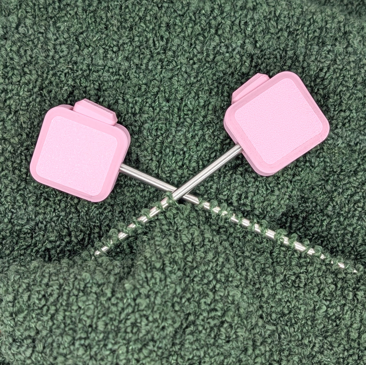 Needle Keepers in Sakura Pink on the needle tips of a knitting project