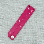 Swatch Gauge in Plum, folded flat, 10 cm side