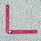 Swatch Gauge in Plum, open to a right angle, 10 cm side