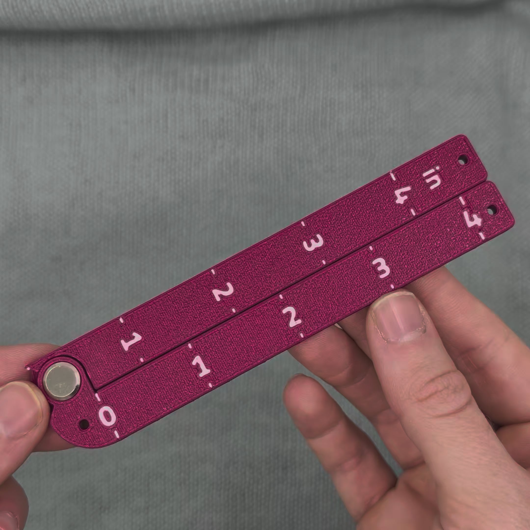Swatch Gauge in Plum, opening to a right angle and folding flat